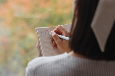 Midsection of woman using mobile phone