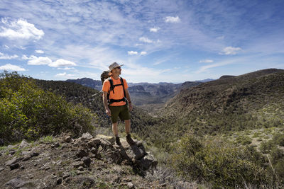 Man takes in nature view from trail overlooking superstition mountains