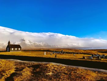 Scenic view of field against blue sky