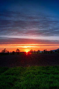 Scenic view of field against sky during sunset