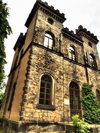 Low angle view of old building against sky