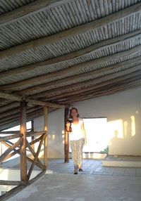 Woman smiling while standing on wood