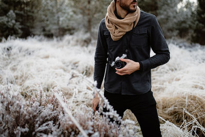 Full length of woman standing on snow covered land