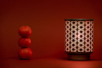 Close-up of oranges on table against wall