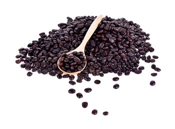 Close-up of roasted coffee beans against white background