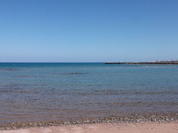 View of sea against clear blue sky