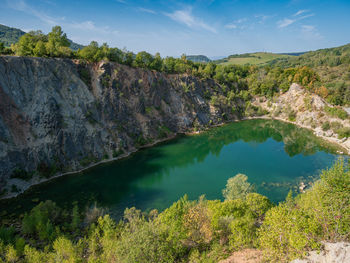 Scenic view of lake by mountain against sky
