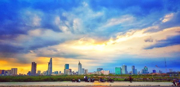 Panoramic view of buildings against cloudy sky