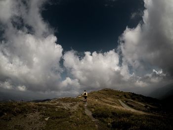 Man standing on mountain against sky