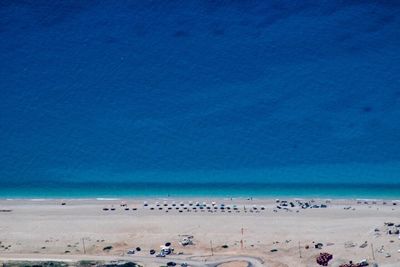 Scenic view of beach against clear blue sky