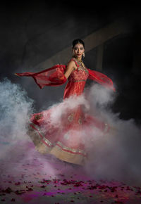 Indian woman wearing traditional dress and dancing