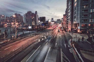 View of city street and buildings against sky