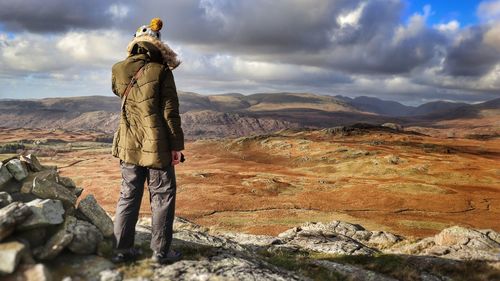 Explorer view of woman standing on mountain against sky lake district