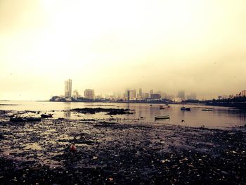 View of calm sea with cityscape in background