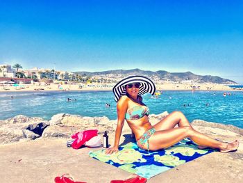 Rear view of a young man relaxing on beach