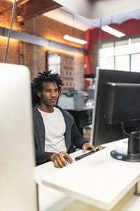 Man using desktop pc at desk in office