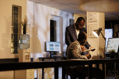 Side view of man using digital tablet in office