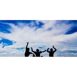 Low angle view of people against clear sky