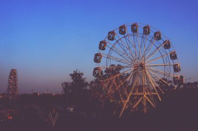 Low angle view of ferris wheel against sky