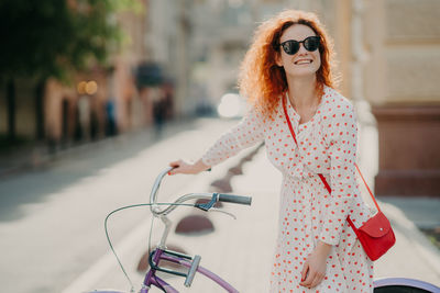 Portrait of woman riding bicycle on city