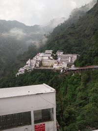 Houses on mountain against sky