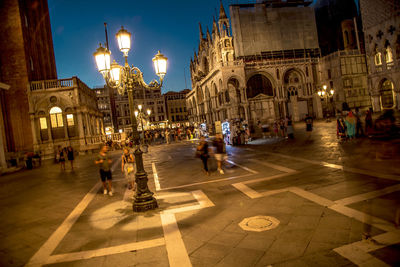 People on street in city at night