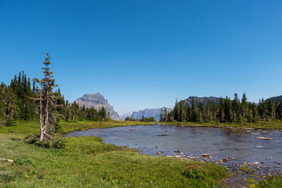 Scenic view of mountains against clear blue sky