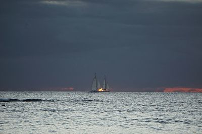 Sailboat sailing on sea against sky