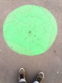 Low section of man standing on tiled floor