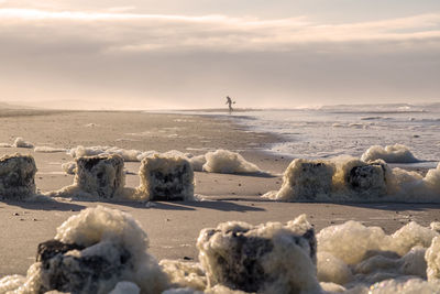 Kid playing with sand on the beach in november sandybeach dutch landscape autumn colors