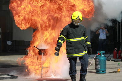 Rear view of man welding on fire