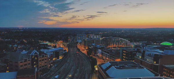 High angle view of illuminated buildings against sky during sunset