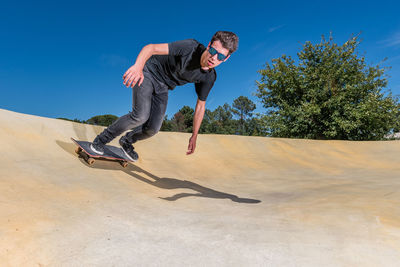 Full length of man skateboarding in park