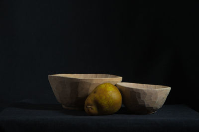 Close-up of fruits on table against black background