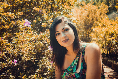 Portrait of smiling woman against plants