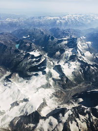 Aerial view of snowcapped mountains against sky