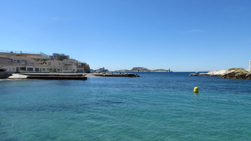 Scenic view of sea against clear blue sky