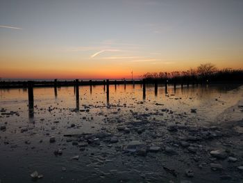 Scenic view of beach against sky during sunset