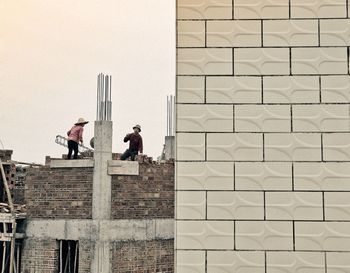 People on wall of building