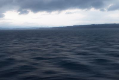 Scenic view of sea against storm clouds