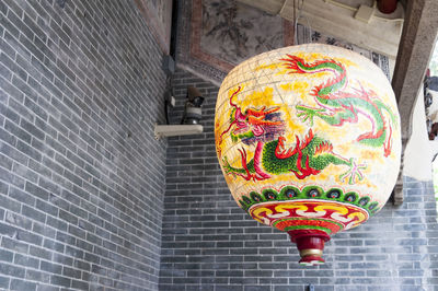 Low angle view of lanterns hanging on wall