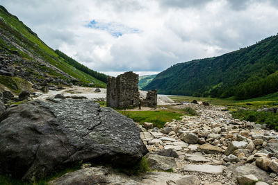 View of castle on mountain against cloudy sky