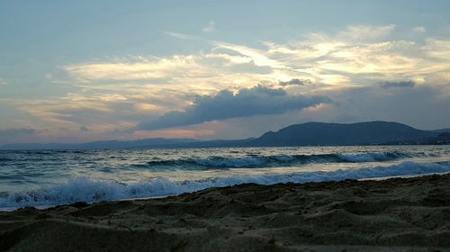 Scenic view of sea against cloudy sky