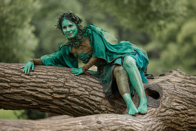 Low angle view of woman standing on rock