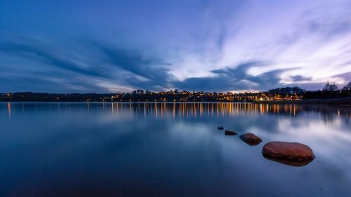 Scenic view of lake against sky at dusk