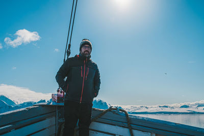 Low angle view of man standing on snow