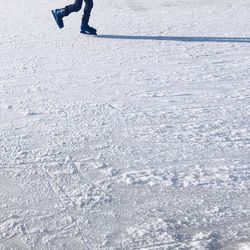 Low section of girl ice skating