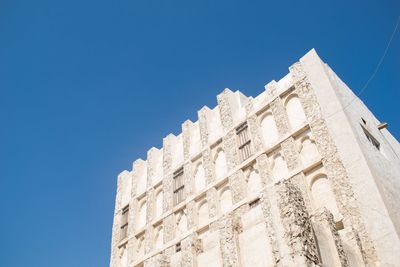 Low angle view of building against blue sky