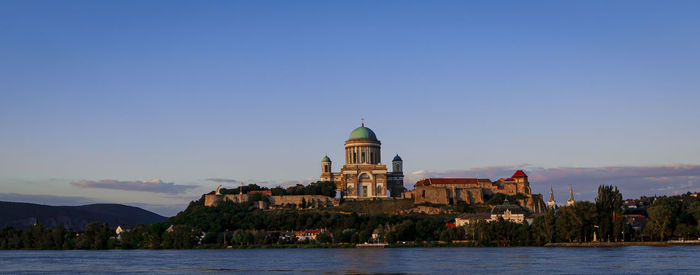 Buildings at waterfront against sky