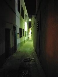Narrow walkway along buildings at night